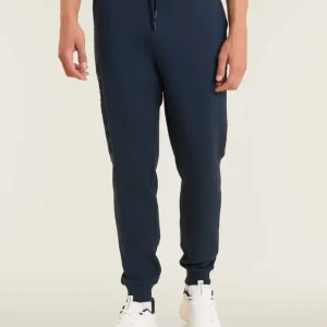 Pantaloni slim in interlock con maxi logo in rilievo